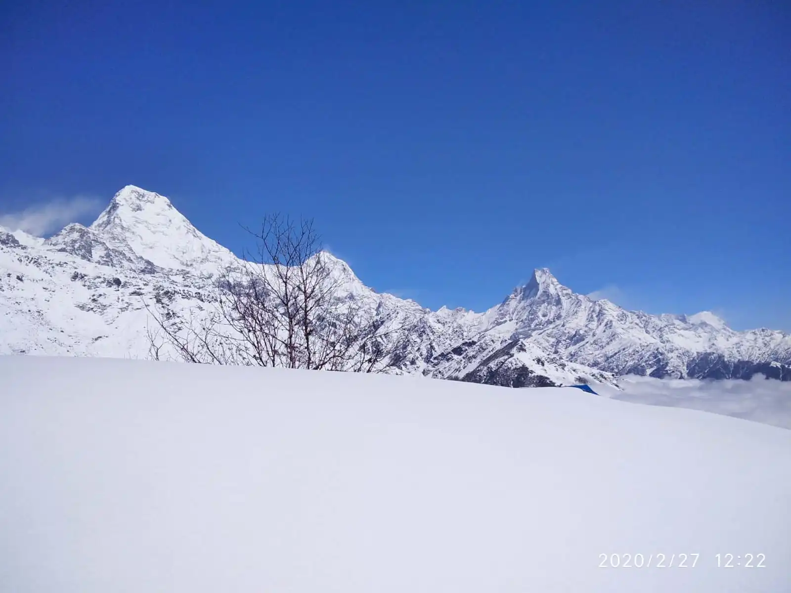Snow-covered slopes facing Annapurna South and Machhapuchhre peaks seen during Mohare Danda Trek
