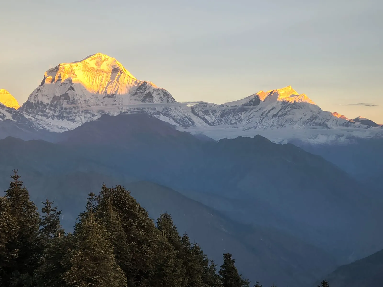 Close-up view of the massive snow-covered summit of Annapurna South under a clear blue sky